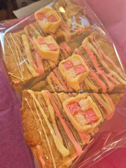4 slices of battenberg cookie pie slices wrapped in clear cellophane on pink tissue paper