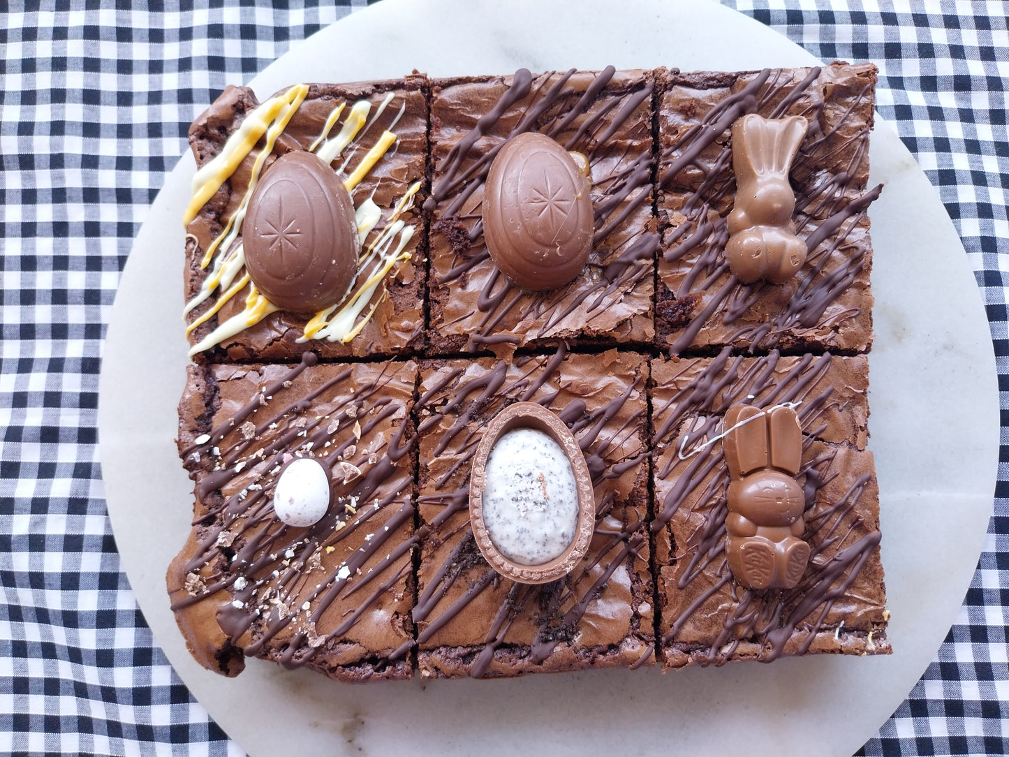 Six chocolate brownies decorated with assorted Easter chocolates including Mini Eggs, Creme Eggs, Oreo Egg, Cadbury Caramel Egg, Malteser Bunny, Kit Kat Bunny