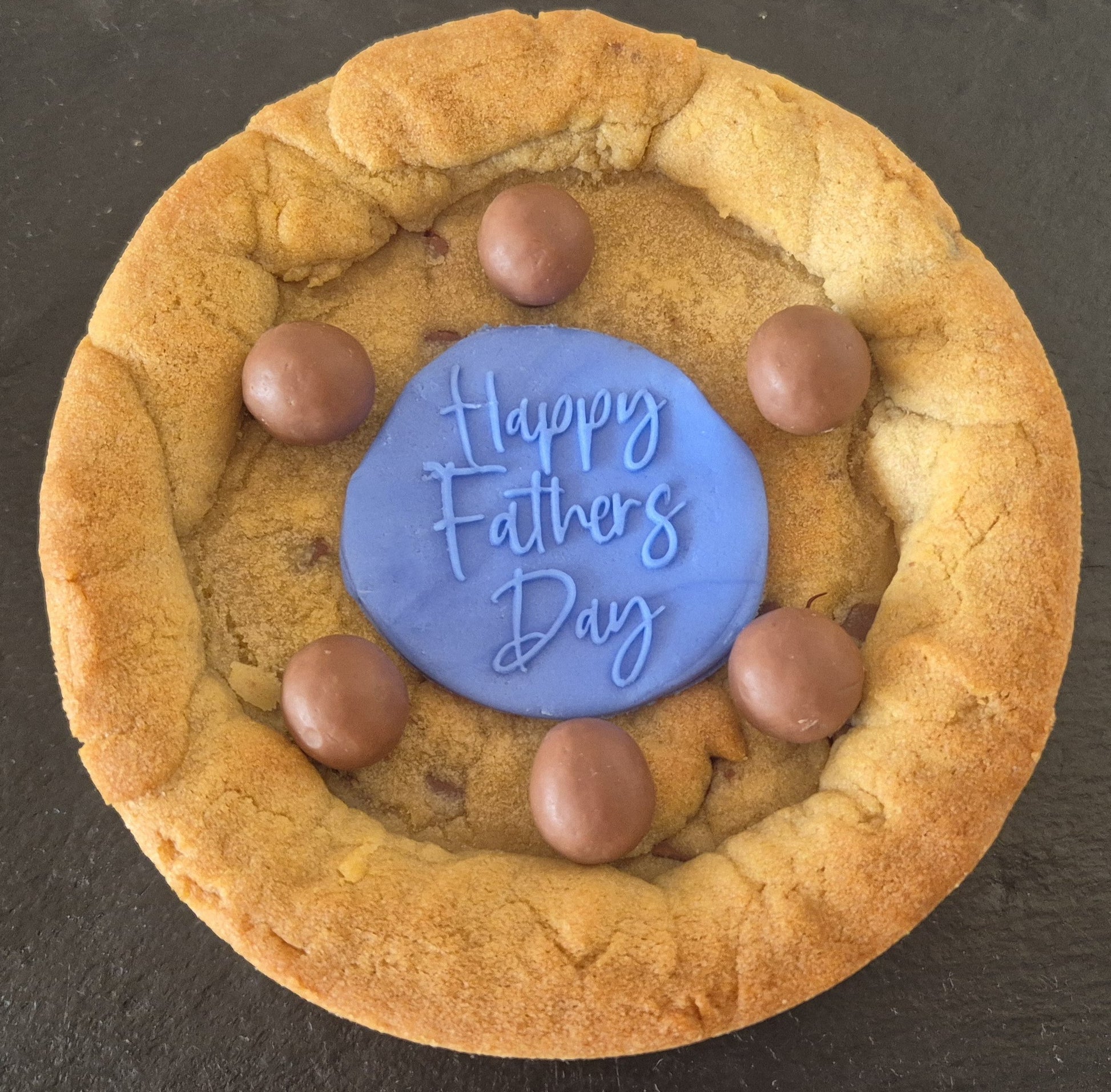 Cookie pie decorated with Maltesers and a blue fondant topper which says Happy Father's Day