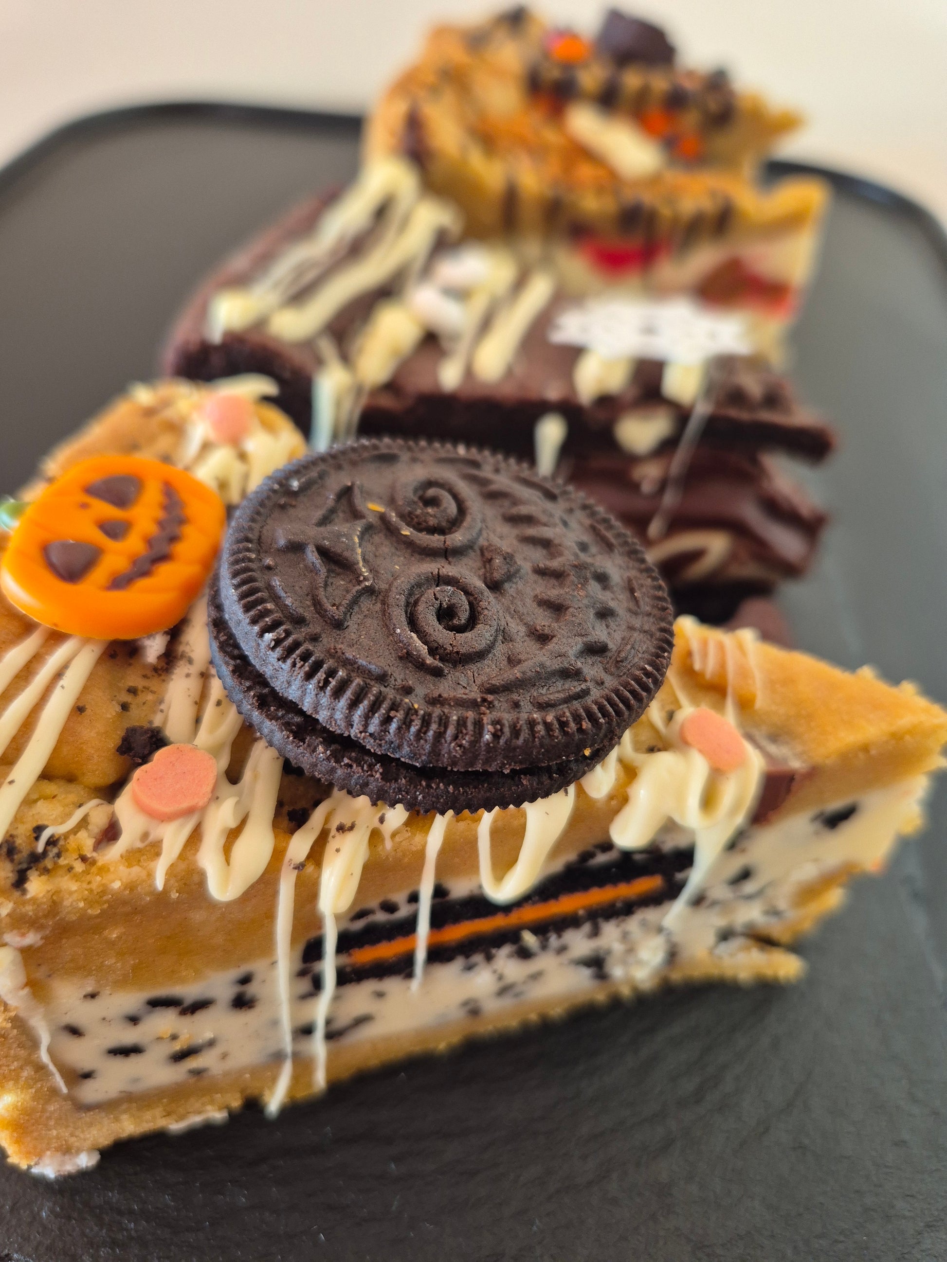 Four Halloween-themed cookie pies on a dark surface