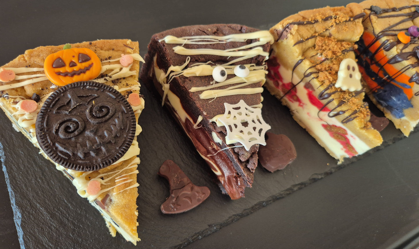 Four Halloween-themed cookie pie slices on a dark surface