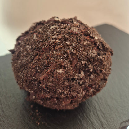 Chocolate Oreo brownie scotch egg with cookie crumb topping on a dark slate surface
